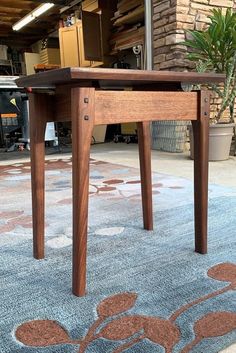 a wooden table sitting on top of a blue rug