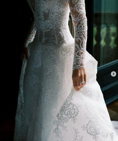 a woman in a white wedding dress is holding her hand out