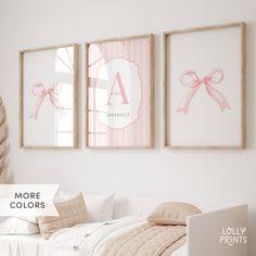 three framed pictures hang on the wall above a bed in a room with pink and white decor