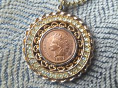 Luck be a lady tonight with this fun nostalgic vintage medallion fashion goldtoned 1901 indian head penny pendant necklace! The coin pendant is bedecked with clear rhinestones for some sparkle and sold on a goldtoned 22 inch ball chain. It measures 1.5 inches across and shows some signs of wear which actually imbues some love and character to this piece. Hit the slots or craps table with this baby on and get ready to rack it in or rub some luck on another for a cool coin collector, gambling enth Craps Table, Luck Be A Lady, Penny Necklace, Be A Lady, Great Graduation Gifts, Vintage Medallion, Craps, Indian Head, Mothersday Gifts