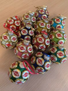 a pile of beer bottle caps sitting on top of a wooden table