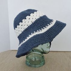 Hand crochet sun hat with a flexible  brim is crocheted  in marine blue  and white cotton yarns.  Blue cotton yarn alternate with a white yarn striping for the hat band and on the brim.  The crochet is a sturdy close  stitch giving the hat good body and shading coverage when worn at the  beach or gardening.  With the flexible brim you have a versatility of styling the hat as you please and the hat folds neatly for packing.  The size of the hat will fit most adult women or teens.  Hand wash cold Blue Crochet Hat, Crochet Sun, Crochet Sun Hat, Summer Sun Hat, Blue Crochet, Le Crochet, Marine Blue, Beach Hat, Crochet Hat