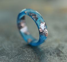 * ONE blue resin ring from my resin jewelry collection * resin band ring - 4-5 mm/0.16 - 0.19 inches/width  * thickness - about 2.3 - 2.5 mm/about 0.09 inches/ * faceted ring with unique flakes pattern * natural color ring - ocean blue ring with copper flakes/rose gold leaf * resin ring men and women, unisex   You can see the other resin rings from the collection here: https://www.etsy.com/shop/ARTISUNtis?ref=seller-platform-mcnav&section_id=15714637 Features: * Hypoallergenic ring (suitable for the people with metal allergy) * For everyday and for special occasions * Perfect gift for you or for the special one in your life  * Stacking ring - you can wear it on its own or stacked with some other rings * Simple and elegant design * Comfort fit ring for wearing * Lightweight ring - pleasant Unique Blue Resin Rings, Blue Resin Rings For Gifts, Blue Resin Rings Perfect As Gifts, Blue Resin Rings Perfect For Gifts, Handmade Blue Resin Rings, Resin Rings, Faceted Ring, Unique Birthday Gift, Blue Ring