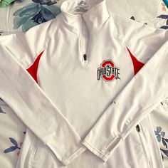 Lightweight Fleece Lined Ohio State University 1/4 Zip Pullover. Zippered Pockets. Thumbholes. Embroidered Logos. White Fleece Half-zip Top, White Fleece Winter Activewear, White Fleece Activewear For Winter, Winter White Fleece Activewear, White Half-zip Sportswear Activewear, Fall White Moisture-wicking Activewear, White Moisture-wicking Activewear For Fall, White Activewear For Fall Sports, White Activewear For Sports In Fall