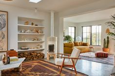 a living room filled with furniture and a fire place next to a painting on the wall