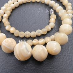 Vintage ~ round Mother or pearls (MOP ) ~ graduating size bead /beaded necklace ~ necklace has barrel clasp at end  Dates mid to late 20th century . Material : MOP metal Measurements: necklace is 17 1/4  inches in length x 1/2 inches max width (min size of 1/4 inches )  . Weighs 33 grams on my weighing scale . Condition :  good vintage condition with very less surface wear to beads ~ No major cracks or chips to the beads . Please Note ~ As vintage items are previously loved /used please do expect some minor wear like surface wear /dents /dings and metal discoloration . All items are carefully inspected and major flaws will be listed separately ~ Plenty of photograph are added so please study the photos carefully as it is also part of description or if you need more pictures just message us Round Pearl Necklace With Large Beads For Jewelry Making, Single Strand Pearl Necklace With Round Beads, Large Beads Pearl Necklace, Pearl Beaded Necklaces With Gemstone Beads, Round Pearl Beaded Necklaces With Gemstone Beads, Pearl Necklace With Large Round Beads, Classic Round Large Beads, Classic Large Round Beads, Round Pearl Beaded Necklaces With Polished Beads