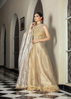 Gold & Silver fully handworked lehnga choli in tissue with tilla, zardozi and dabka along with a silver tissue duppata, with a spray of motifs & kiran edging Floor-length Raw Silk Lehenga With Dabka Detail, Floor-length Raw Silk Lehenga With Dabka, Gold Lehenga With Dabka For Festive Occasions, Raw Silk Dupatta With Dabka For Reception, Festive Gold Lehenga With Dabka Detailing, Eid Silver Raw Silk Set, Gold Raw Silk Lehenga With Dabka Detailing, Semi-stitched Lehenga In Dola Silk With Dabka Details, Semi-stitched Dola Silk Lehenga With Dabka