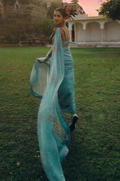 Ice blue organza saree with sequins flower hand embroidery. Comes with a tissue silk unstitched blouse piece.
Components: 2
Pattern: Hand embroidered
Type Of Work: Sequins flower
Fabric: Saree : Organza, Unstitched Blouse : Tissue silk
Color: Blue
Other Details: 
Blouse length : 1.25 mtrs
Note : Stitched blouse worn by the model is not for sale.
Occasion: Mehendi and Haldi,Sangeet - Aza Fashions Designer Pre-draped Organza Saree For Eid, Navratri Party Wear Organza Blouse Piece, Party Wear Organza Blouse Piece For Navratri, Navratri Party Wear Blouse Piece In Organza, Designer Blue Organza Pre-draped Saree, Blue Organza Pre-draped Saree With Dupatta, Party Wear Organza Saree With Unstitched Blouse, Bollywood Style Organza Pre-draped Saree With Sheer Dupatta, Organza Pre-draped Saree With Sheer Dupatta