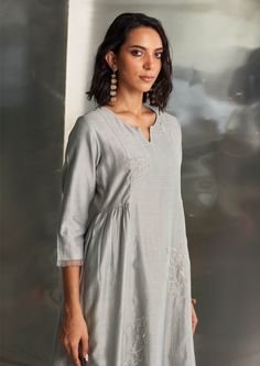 Embrace the elegance of steel grey with this exquisite kurta set by Charkhee, featuring intricate nakshi antique silver handwork. The side-gathered design and flowing silhouette exude timeless grace, perfect for any occasion. Complete your look with a dreamy pure organza dupatta adorned with nakshi handwork and a flowy bottom with scalloped edges for a glamorous finish. The bottom is elasticated with a drawstring for added comfort. Grey Kurta Women, Grey Kurta, Chanderi Kurta, Pant Set For Women, How To Hem Pants, Organza Dupatta, Kurta With Pants, Satin Color, Steel Grey