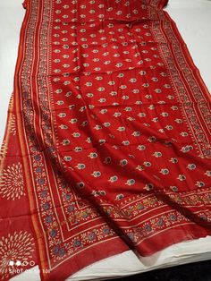 This is a beautiful  chanderi silk cotton saree with ajrakh  printed design  Fabric - Chanderi cotton silk  Technique - Hand block printed. Saree length - 5.5 mtr. Blouse - 1 mtr. Running . Easy wash and care . Please note - color may be vary a little due to sunlight and photography . Please message us after purchasing in case you want fall and Pico done. No extra charges for fall and Pico but inform us . Blouse stitching is also available . Bohemian Cotton Silk Saree With Bandhani Print, Bohemian Cotton Silk Bandhani Print Saree, Red Kalamkari Print Traditional Wear In Cotton Silk, Red Cotton Silk Traditional Wear With Kalamkari Print, Red Cotton Silk Saree With Kalamkari Print, Bohemian Kalamkari Print Katan Silk Saree, Bohemian Katan Silk Saree With Kalamkari Print, Bohemian Kalamkari Katan Silk Saree, Bohemian Cotton Silk Saree With Block Print