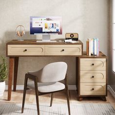 a desk with a computer on top of it and a chair in front of it