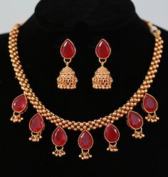 Traditional Maharashtrian Jewelry Thushi Necklace Set design with red and green teardrop stones. The necklace set comes with matching pair of jhumka type earrings with push back lock. Festive Teardrop Necklace For Celebration, Red Temple Jewelry With Latkans, Traditional Teardrop Bridal Necklace For Celebration, Temple Jewelry Teardrop Earrings For Celebrations, Ruby Latkans Temple Jewelry, Red Stone Work Temple Jewelry Jhumkas, Red Necklaces With Latkans For Diwali, Red Temple Necklace With Latkans For Gifts, Heavy Red Jewelry For Puja