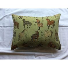 a green pillow with horses on it