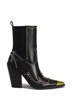 Elevate your style with the TORRIN-BLACK STUDDED ANKLE BOOTIE. This pointed toe bootie features faux leather, western-inspired design, and gold hardware and studded embellishments. With its sleek and edgy look, this bootie is the perfect way to add a fun flare to any outfit.  Shaft Height: 6.5" Opening Circumference: 13" Heel Height: 4.5" Shoe Trends Fall 2024, Western Booties Outfit, Edgy Western Style, Glastonbury Outfits, Formal Boots, Womens Fall Boots, Rocker Chic Style, Urban Shoes, Western Vibes