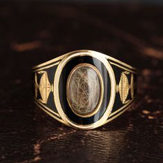 This mourning ring is decorated with exquisitely rendered urns on each shoulder and the name and death details of the deceased, "Edwd [Edward] Down Esq Ob 23 June 1806 Ae 63". The title of "Esquire" was pretty much an honorary one at the time this ring was made. It indicates that Mr. Down, though not a member of the gentry, was a high status person in his community and probably quite wealthy. His hair is coiled under the glass. 1800s Jewelry, Hair Locket, Victorian Hair, Georgian Ring, Georgian Jewelry, Dope Jewelry, Colored Gems, Memento Mori, Enamel Jewelry