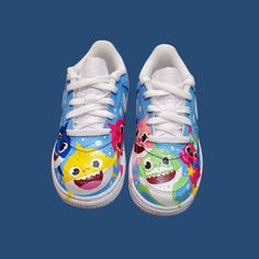 Custom hand painted air force 1 shoes. Baby shark character theme . Prices vary depending size. Cost of shoes included in the price. Fun Low-top Sneakers With Cartoon Print, Blue Sneakers With Custom Artwork, Hand Painted Air Force 1, Shark Character, Painted Air Force 1, Air Force 1 Shoes, Sneakers Athletic, Theme Birthday, Custom Hand Painted