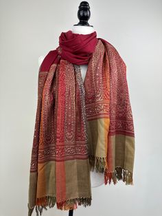 "This is an all season wool shawl that measures 38\"\"W X 85\"L An XL blanket scarf or sofa throw in maroon, red, orange, and green with bead embellishments is a festive and versatile accessory.  Elevate your cozy evenings with our XL blanket scarf, a stylish and warm addition to your home. This maroon, red, orange, and green throw is adorned with delicate bead embellishments, adding a touch of festive charm to your space. ✨ Festive Elegance: The rich and vibrant colors of maroon, red, orange, and green make this blanket scarf the perfect companion for the holiday season. The added bead embellishments lend a touch of elegance and sparkle, making it an ideal festive wrap. 🛋️ Versatile Home Decor: Use it as a sofa throw to instantly transform your living room into a cozy and inviting space. Red Fall Pashmina Shawl, Red Pashmina Shawl For Fall, Red Wool Shawl For Fall, Red Embroidered Pashmina Scarves, Festive Red Scarf With Traditional Drape, Red Bohemian Pashmina Shawl, Red Embroidered Shawl Scarf, Red Festive Shawl Scarves, Festive Red Shawl Scarf