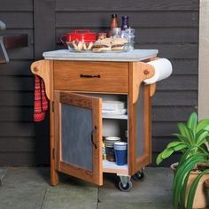 an outdoor kitchen cart with food on top