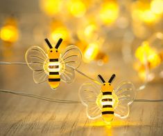 two bees sitting on top of each other with lights in the back ground behind them