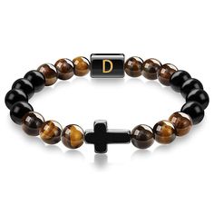 "This Item is Handmade" Enhance your spiritual journey with our Cross Tiger Eye Bracelet with Initial Charm. This exquisite piece is crafted from high-quality Tiger Eye stones, known for their protective and grounding properties. The beaded bracelet features a stylish cross pendant and a customizable initial letter, making it a perfect personalized bracelet for both men and women. Each handmade bracelet is meticulously designed to bring you good luck and protection. The durable elastic cord ensures a comfortable fit, while the natural stone beads offer a touch of elegance to any outfit. Whether you're looking for a fashion accessory or a meaningful gift, this bracelet is the ideal choice. Features: Natural Tiger Eye Stones: Known for their protective and grounding properties. Cross Pendant Spiritual Adjustable Wristband With Letter Beads, Adjustable Spiritual Wristband With Letter Beads, Spiritual Beaded Adjustable Name Bracelet, Adjustable Beaded Spiritual Name Bracelet, Adjustable Spiritual Crystal Bracelet With Polished Beads, Adjustable Natural Stones Rosary Bracelet For Meditation, Adjustable Rosary Bracelet With Natural Stones For Meditation, Spiritual Letter Beads Wristband, Adjustable Symbolic Gemstone Beaded Bracelets