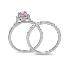 Ask for her hand with this romantic gemstone and diamond bridal set. Crafted in cool 14K white gold, the engagement ring showcases a 7.0 x 5.0mm oval-shaped bright pink sapphire center stone wrapped in a halo frame of shimmering diamonds. The ring's shank is also lined in diamonds. On your wedding day, the coordinating sparkling diamond-lined band completes the ensemble. Radiant with 5/8 ct. t.w. of diamonds and a brilliant buffed luster, this must-have bridal set is designed to delight. Dazzling Bridal Sets With Center Stone For Promise Ring, Diamond Bridal Sets With Round Cut For Promise, Diamond Bridal Set With Brilliant Cut For Promise, Pink Platinum Wedding Rings, Brilliant Round Cut Bridal Sets, Bridal Sets With Halo Setting, Elegant Bridal Sets With Halo Setting, White Gold Bridal Sets With Halo Setting, White Gold Bridal Set With Round Band