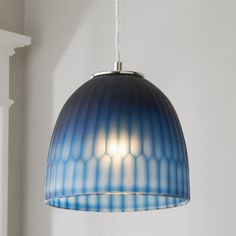 a blue and white lamp hanging from a ceiling