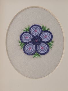 a blue and white flower is in the middle of a circle