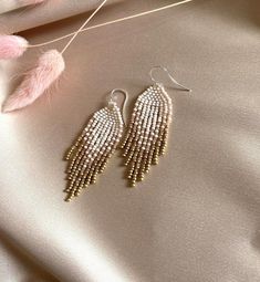 These fringe ombre  beaded earrings are made of high quality Czech beads. Colors: beige, dusty pink, gold--------------------------------------------✦ The Details:✔ Made with quality Czech beads✔ Made using strong bead weaving thread. ✔ Lenght: app. 2 inches✔ Sterling silver earrings hooksThere may be some color discrepancies which is due to the different monitor settings✦ All  earrings hooks are nickel and lead free!✦ More great boho earrings found here https://www.etsy.com/shop/LiliBeadShopFol Handwoven Earrings, Beads Colors, Ombre Earrings, Earrings Patterns, Dangle Earrings Boho, Boho Style Earrings, Gold Dangle Earrings, Earrings Diy, Beaded Dangle Earrings