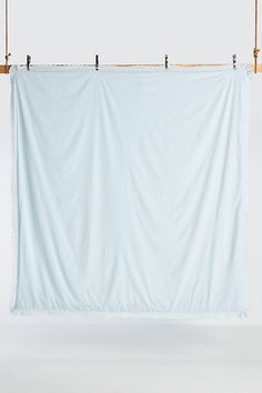 a white backdrop hanging from a wooden pole