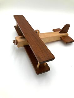 a wooden toy airplane sitting on top of a white table