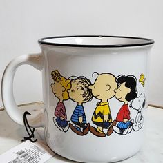 a white coffee mug with the image of three cartoon characters on it and a price tag