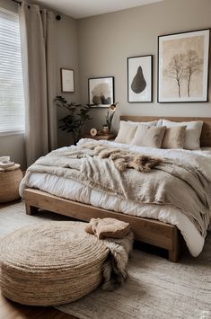 a large bed sitting in a bedroom on top of a wooden floor next to a window