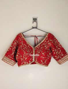 Stunning red blouse in upada silk with gold thread and sequin embroidery. It has hooks on the front and the sleeves are elbow length. This blouse is a versatile piece that can be paired with a sari or a lehenga to  make a perfect festive outfit. This blouse can be made in ANY COLOR. Pls send us a convo if you want it in a different color.  MEAUREMENTS & CUSTOMIZATIONS This blouse can be purchased in your standard sizing and pattern. Please choose your Chest Size (measured in inches) from the drop-down box. This blouse can be customized. We can make in any color, size and pattern.  Incase you need any customizations, please drop us a convo. For custom sizing please include the below measurements in the the notes to whenever you placed the order.  * Chest size: * Waist size: * Blouse Length: Red Semi-stitched Blouse For Navratri, Red Saree Blouse With Pallu, Red Saree Blouse With Pallu Detail, Red Semi-stitched Unstitched Blouse Piece, Red Semi-stitched Blouse For Diwali, Red Semi-stitched Blouse For Festivals, Semi-stitched Red Blouse For Diwali, Semi-stitched Red Unstitched Blouse Piece, Navratri Red Cutdana Blouse