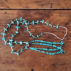 This beautiful turquoise necklace is 36.5" in length and has long, free moving beads that hang from the center of the necklace. This long turquoise necklace is lightweight and easily slips over the head for convenience. It is extremely comfortable.  It is most likely handcrafted from Morenci turquoise or Kingman turquoise beads, spaced with brown shell heishi beads.   We estimate this necklace to be made in the mid 1970's and is in good vintage condition. A single bead at the bottom of the turqu Turquoise Hand-strung Lariat Beaded Necklace, Turquoise Lariat Beaded Necklace Hand-strung, Rustic Turquoise Hand-strung Necklace, Southwestern Beaded Lariat Necklace, Turquoise Lariat Beaded Necklace For Festival, Turquoise Long Hand-strung Beaded Necklaces, Southwestern Lariat Turquoise Necklace, Southwestern Turquoise Beaded Necklaces For Beach, Adjustable Southwestern Turquoise Lariat Necklace