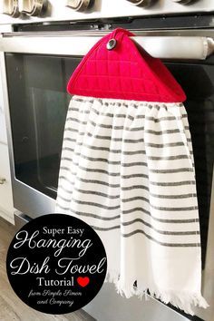 a dish towel hanging from an oven door with the words super easy hanging dish towel