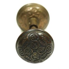 an antique brass door knob with intricate designs