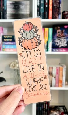 a person holding up a bookmark that says i'm so glad to live in where there are others