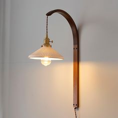 a lamp hanging from the side of a wall