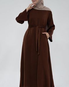 Experience comfort with the Yasmin Slip Dress. This exquisite garment has a maxi length, detachable belt, and kimono sleeves that together create an exquisite, timeless silhouette. Crafted with exquisite attention to detail, it exudes class and grace suitable to wear under abayas or coat or cardigan. The combination of comfort, superior materials and classic design promises a look that pairs perfectly with Clothing, Fashion and Trendy Abayas. Its effortless styling ensures a luxurious presence t Elegant Belted Solid Maxi Dress, Elegant Solid Color Belted Maxi Dress, Elegant Belted Solid Color Maxi Dress, Solid Color Belted Maxi Dress, Solid Colored Belted Maxi Dress, Modest Belted Dresses, Modest Solid Color Belted Dress, Elegant Belted Abaya, Formal Maxi Dress With Belt