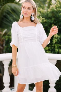 Make the perfect entrance with this exquisite Say I Do Babydoll Dress. Its timeless silhouette and classic design is accentuated with romantic ruching, delicate puff sleeves and a flattering square neckline; detailing that promises to transform your look into something truly special. This dress features short puff sleeves, a square neckline, smocked back, and ruching.  Material has no amount of stretch.Cam is wearing the small. White Babydoll Dress, White Babydoll, Floral Cocktail Dress, Black Tie Dress, Long Sleeve Outerwear, Two Piece Swimwear, Bride Clothes, Friend Outfits, Romper With Skirt