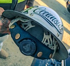 a close up of a person holding a helmet