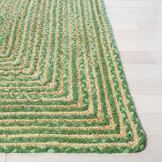 a green and yellow rug is on the floor