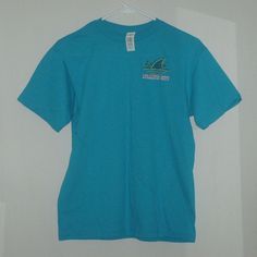 Margaritaville Landshark Surf Shack Atlantic City Double-Sided, Turquoise Colored T-Shirt. Brand New With $18.95 Price Tag And In Size Large. Other Approximate Measurements: 18" Pit To Pit, 18 1/2" Waist And 25" Length. Casual Short Sleeve Shark Design Tops, Casual Short Sleeve T-shirt With Shark Design, Casual Short Sleeve Top With Shark Design, Casual Summer T-shirt With Shark Design, Blue Shark Design Crew Neck Top, Blue Shark Design Short Sleeve Tops, Summer Short Sleeve T-shirt With Shark Design, Summer Short Sleeve Tops With Shark Design, Blue Short Sleeve Top With Shark Design