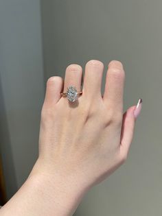 a woman's hand with a diamond ring on it