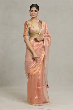 Peach saree with silver stripe placement woven motifs and lace embellished border. - Aza Fashions Transitional Season Sheer Dupatta Saree, Tissue Silk Pre-draped Saree For Designer Wear, Tissue Silk Pre-draped Saree For Navratri, Cotton Silk Saree For Reception, Sheer Dupatta Cotton Silk Choli, Pre-draped Organza Saree With Pallu, Tissue Silk Pre-draped Saree With Dupatta, Designer Wear Pre-draped Organza Saree, Organza Pre-draped Saree With Pallu