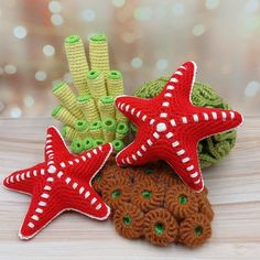 three crocheted starfish and sea urchins sitting on a table next to each other