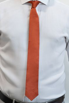 Classic spice, orange color Beautiful satin material Skinny style tie 2.5" wide by 56.5" long 100% polyester Dry clean only * If returning, tie must arrive back to us in original packaging with tags still in place, or it will not be eligible for return. Orange Business Tie, Orange Formal Suit And Tie Accessories, Classic Orange Ties For Business, Classic Orange Tie For Business, Orange Standard Tie For Business, Orange Standard Business Tie, Satin Material, Necktie, Floral Tie