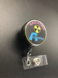 This unique retractable badge holder is adorable and useful. A great gift for any Radiation Therapist! These will be made with a belt clip back. If you prefer a swivel clip, let me know in the notes to seller section when checking out. Thank you!! :) Black Retractable Badge Holders As Gift, Adjustable Black Retractable Badge Holder, Black Adjustable Retractable Badge Holders, Black Retractable Badge Reel For Gift, Black Badge Reel With Swivel Clip As A Gift, Radiation Therapist Gifts, Radiation Therapist, Xray Tech, Retractable Badge Holder