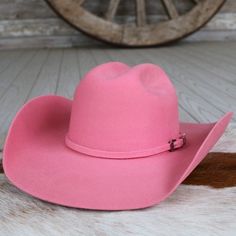 Introducing the Pink Cowboy Hat by Serratelli Hat Company, a genuine American-made accessory tailored for the modern cowgirl. Crafted from 2X wool with a 4.25-inch brim and long oval crown, it offers both style and comfort. The satin lining and leather sweatband ensure a luxurious feel, making it the perfect blend of fashion and function. Elevate your western-inspired look with this chic and versatile piece. 4 1/4" Brim 4 3/16" Crown Color: Pink 2X Wool Made in the USA Long Oval Silver Hats, Beaded Hat Bands, Pink Cowboy Hat, Pink Cowboy, Modern Cowgirl, Felt Cowboy Hats, Kids Belt, Beaded Hat, Western Style Outfits