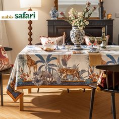 a dining room table covered with a jungle print cloth